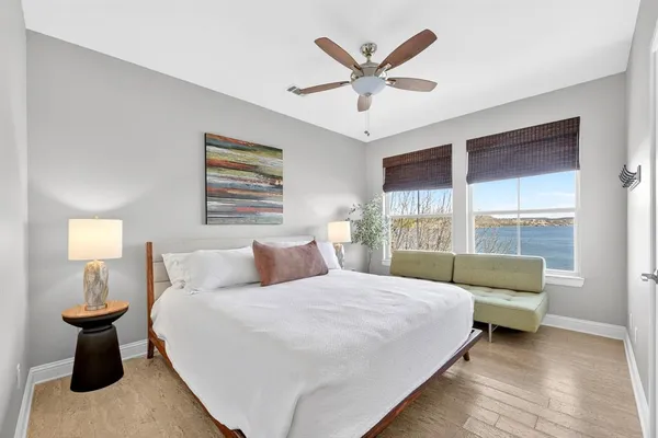 a bedroom with a bed and a large window