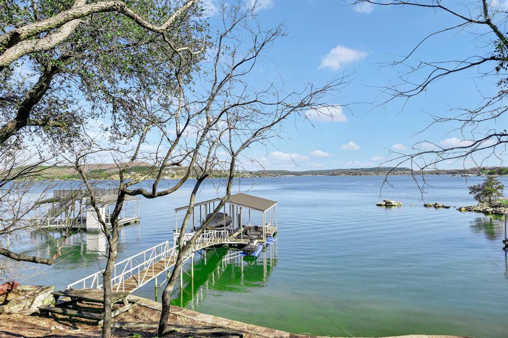 2127 Trail Ridge Road Graford, TX 76449 - Photo 28 of 34 a backyard of a house with table and chairs