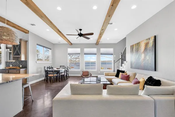 a living room with furniture wooden floor and dining table