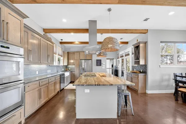 a kitchen with stainless steel appliances granite countertop a sink and a stove