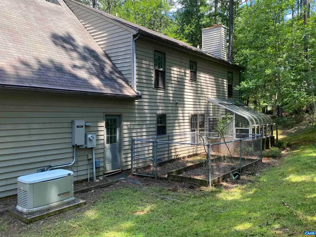 a view of a small house with a yard