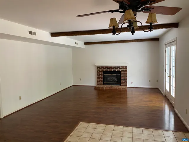 a view of an empty room with a fireplace