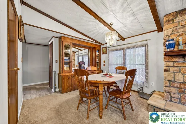 a view of a dining room with furniture and a window