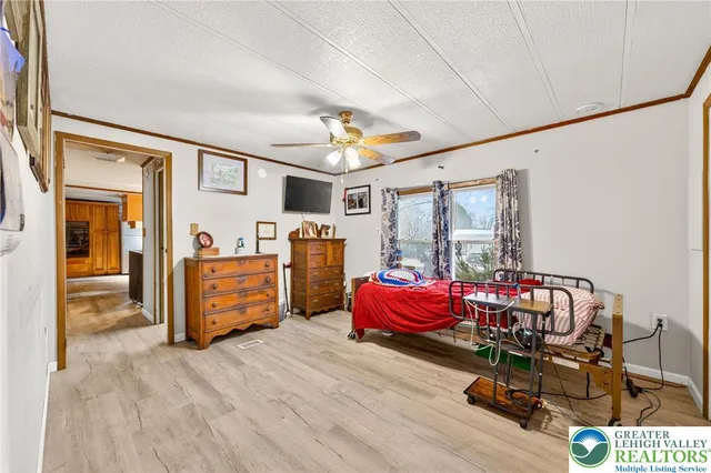 a bedroom with a large bed and a chandelier