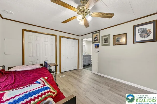 a bathroom with a toilet a sink a mirror and vanity