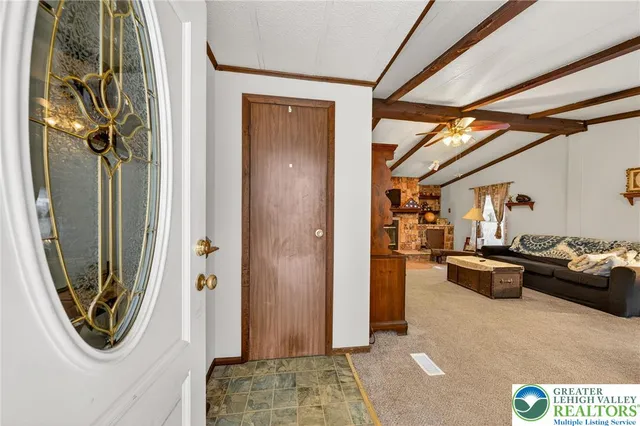 a view of a livingroom with furniture and a window