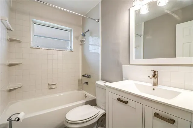 a bathroom with a sink toilet a bathtub and a vanity