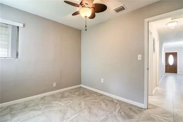 a view of a livingroom with a chandelier fan