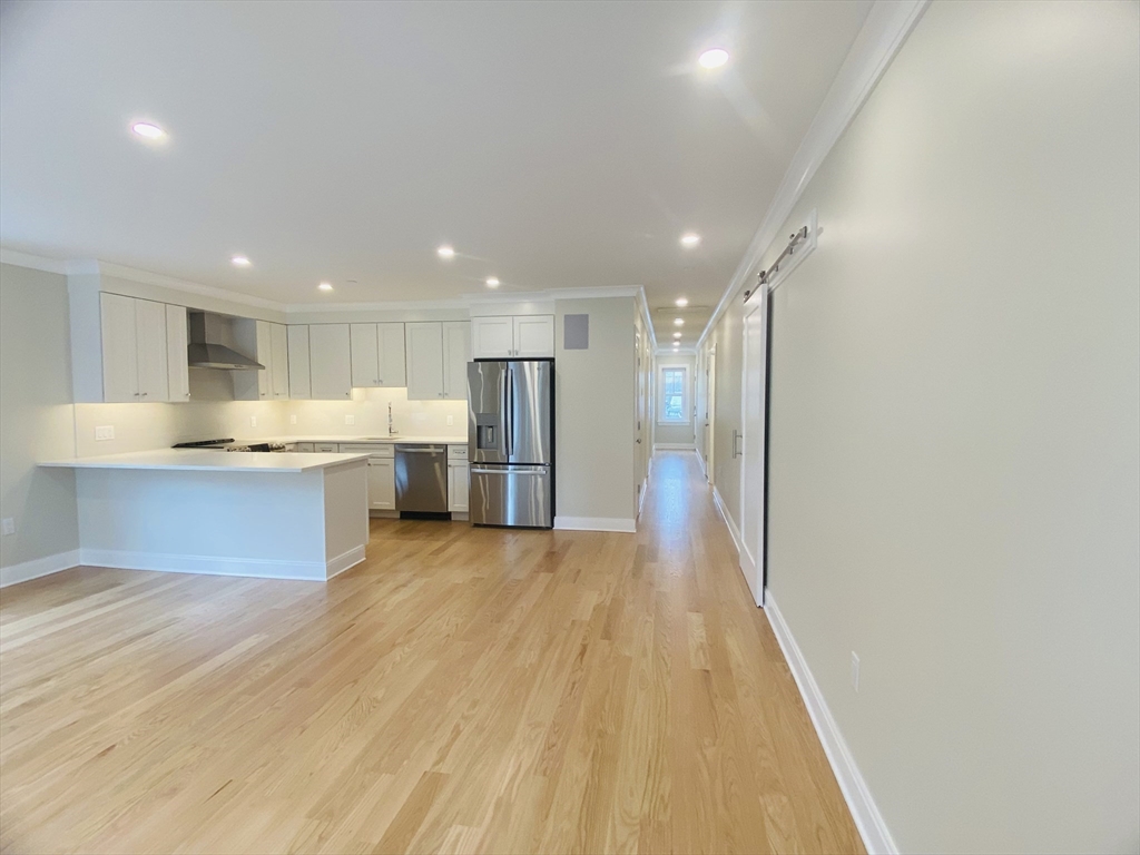 15 Yuill Circle, Unit 2 Boston, MA 02136 - Photo 2 of 16 a view of kitchen with wooden floor