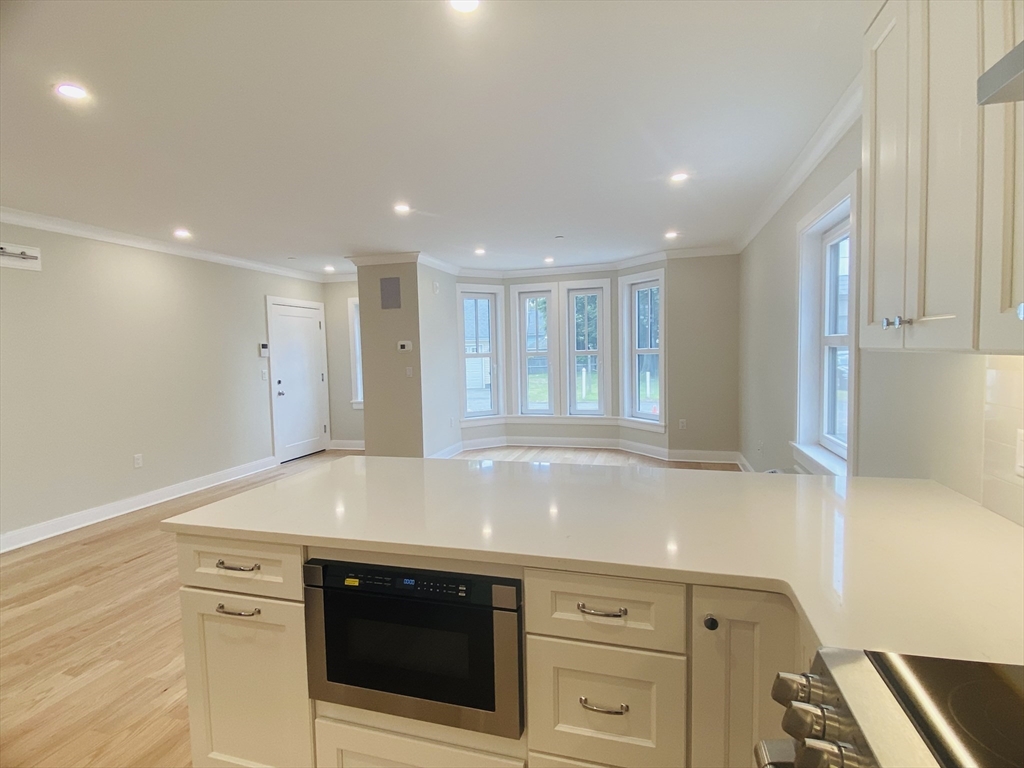 15 Yuill Circle, Unit 2 Boston, MA 02136 - Photo 5 of 16 a view of cabinets and wooden floor