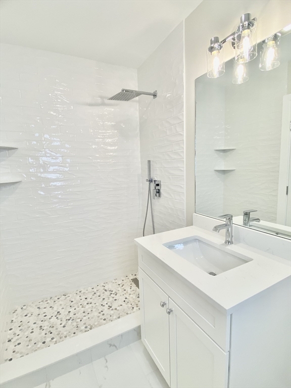 15 Yuill Circle, Unit 2 Boston, MA 02136 - Photo 6 of 16 a bathroom with a sink shower and a mirror