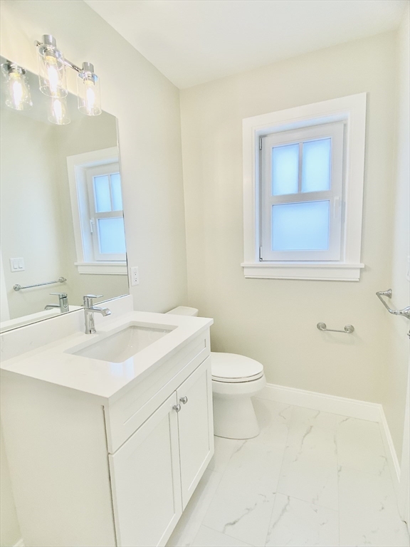 15 Yuill Circle, Unit 2 Boston, MA 02136 - Photo 7 of 16 a bathroom with a sink a toilet and mirror