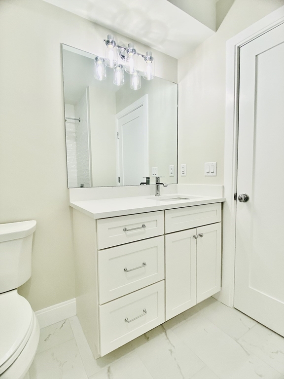 15 Yuill Circle, Unit 2 Boston, MA 02136 - Photo 10 of 16 a bathroom with a toilet sink and mirror