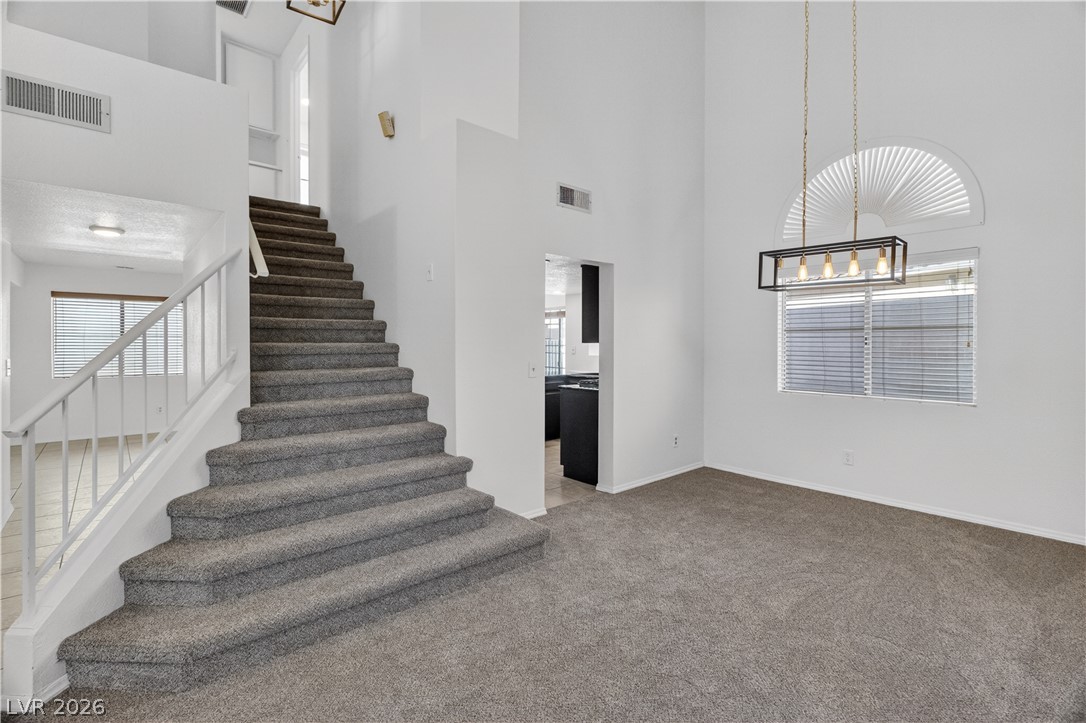 3156 Terrace View Drive Laughlin, NV 89029 - Photo 10 of 94 A grand staircase and high ceilings create an impressive entry to this open-concept home.