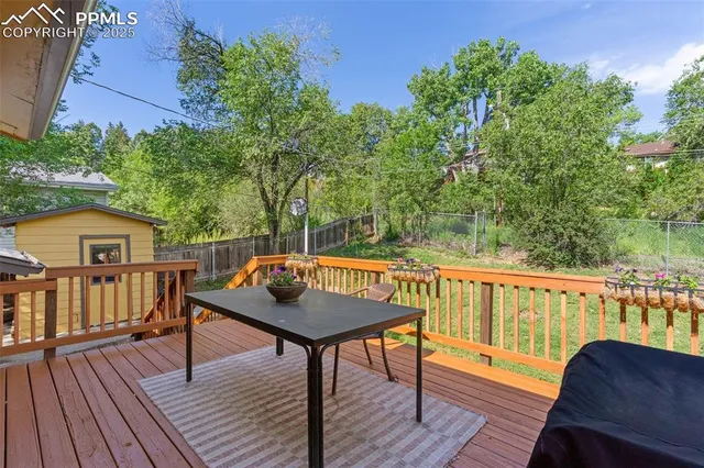a view of a deck with chairs and wooden floor
