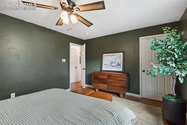 a bedroom with a bed and a potted plant