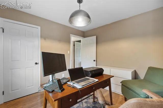 a work room with furniture and wooden floor