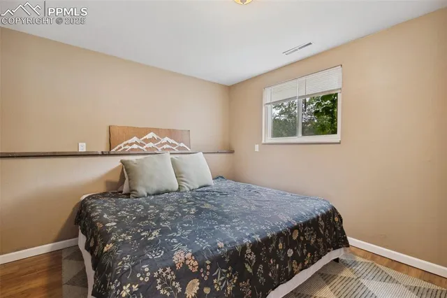 a large bed sitting in a bedroom next to a window
