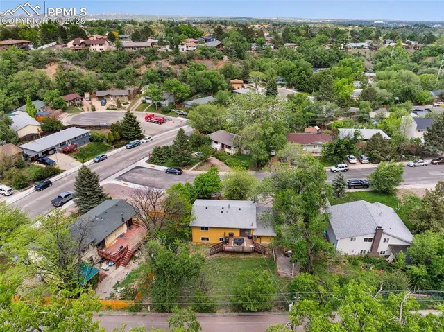 an aerial view of residential houses with outdoor space and street view