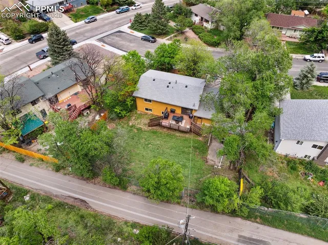 an aerial view of a house with a garden and swimming pool