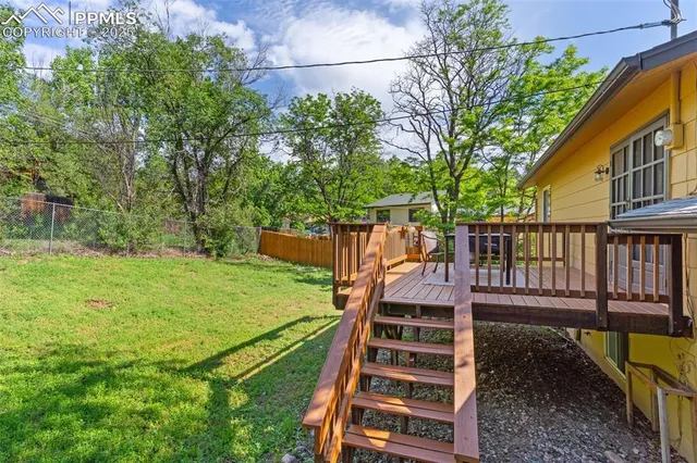 a view of a yard with grass and stairs
