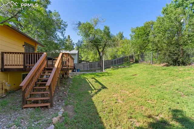 a view of a backyard with swimming pool
