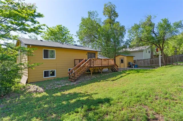 a view of a backyard with a garden and entertaining space