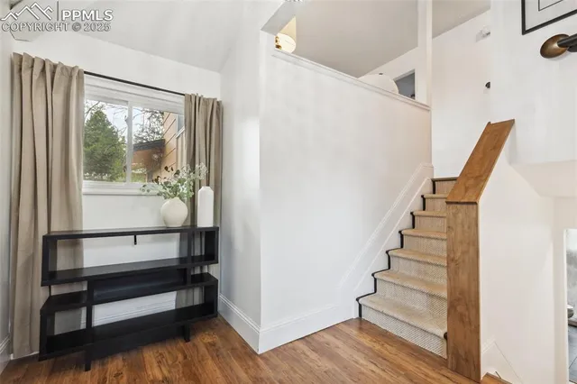 a view of entryway with wooden floor and stairs