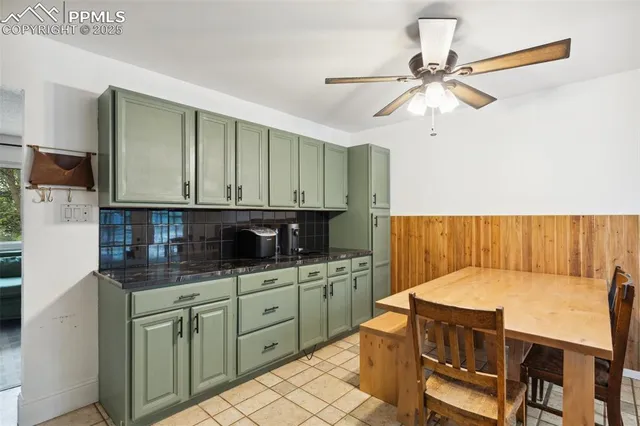 a kitchen with a table chairs refrigerator and cabinets