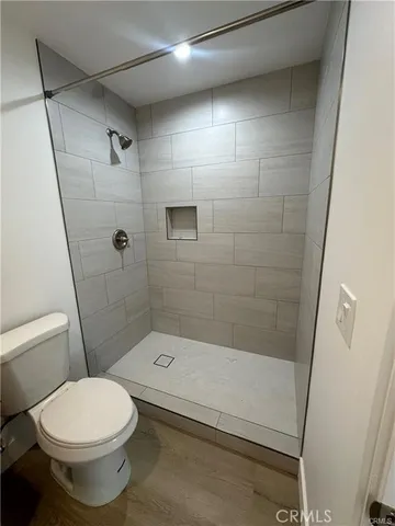 a bathroom with a toilet and a shower