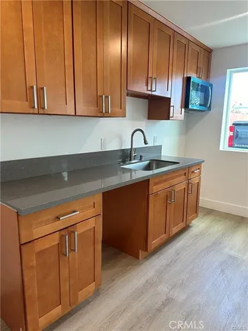 a kitchen with stainless steel appliances granite countertop a sink a stove and cabinets