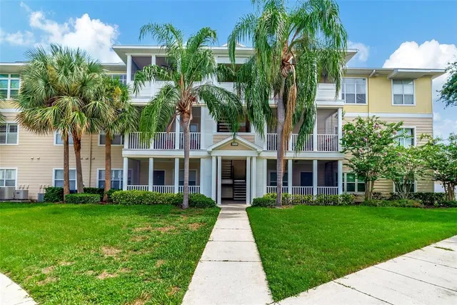 a front view of a house with a yard and potted plants