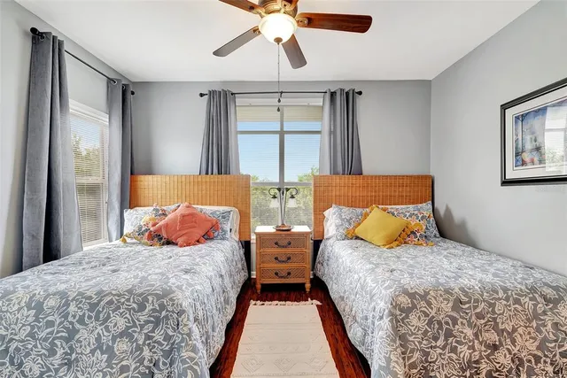 a bedroom with two beds and a chandelier