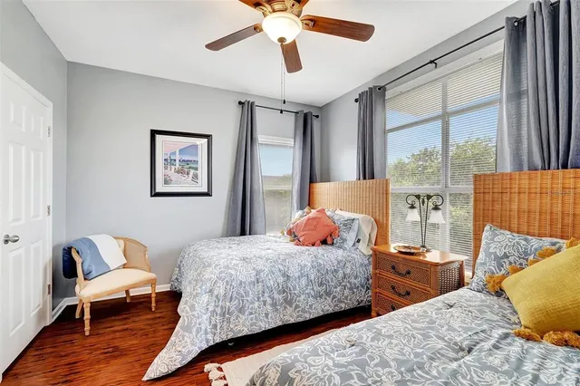 a bedroom with two beds and a chandelier