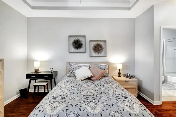 a bedroom with a bed and wooden floor