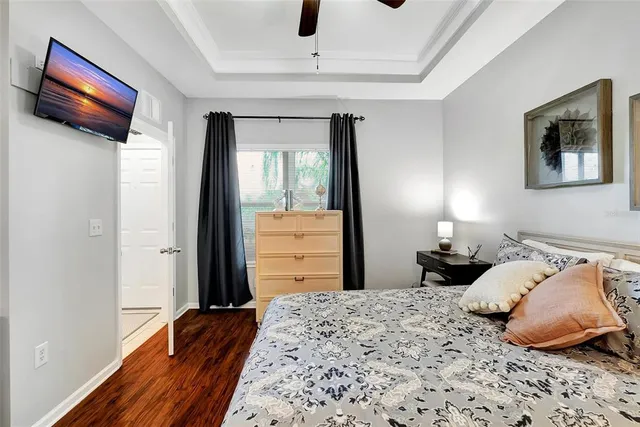 a bedroom with a bed and a flat screen tv