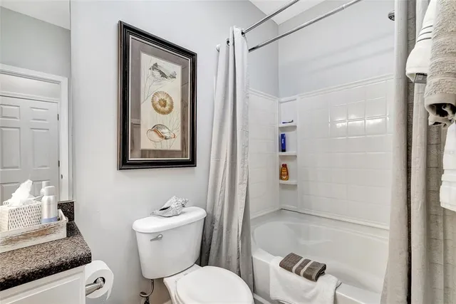 a white toilet sitting next to a bathroom sink