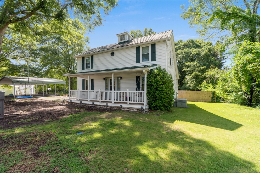 108 Tarrant Street Central, SC 29630 - Photo 2 of 42 A charming country residence with a welcoming covered front porch, set on a verdant lot.