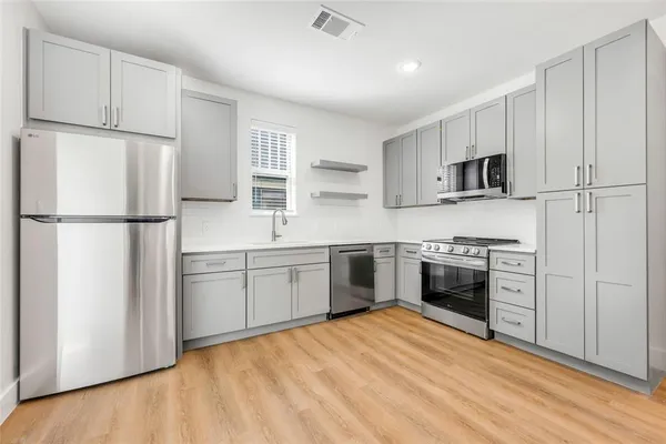 a kitchen with a refrigerator stove and microwave