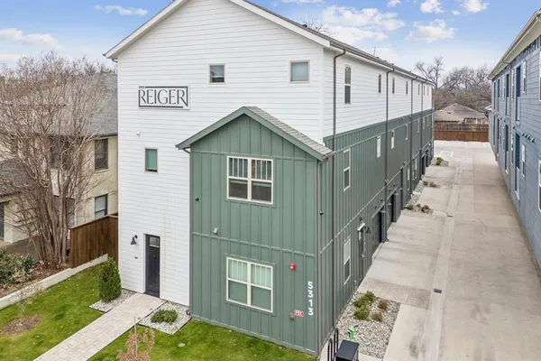 a view of a house with wooden fence