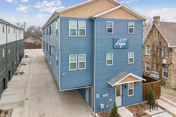 a view of a house with wooden fence