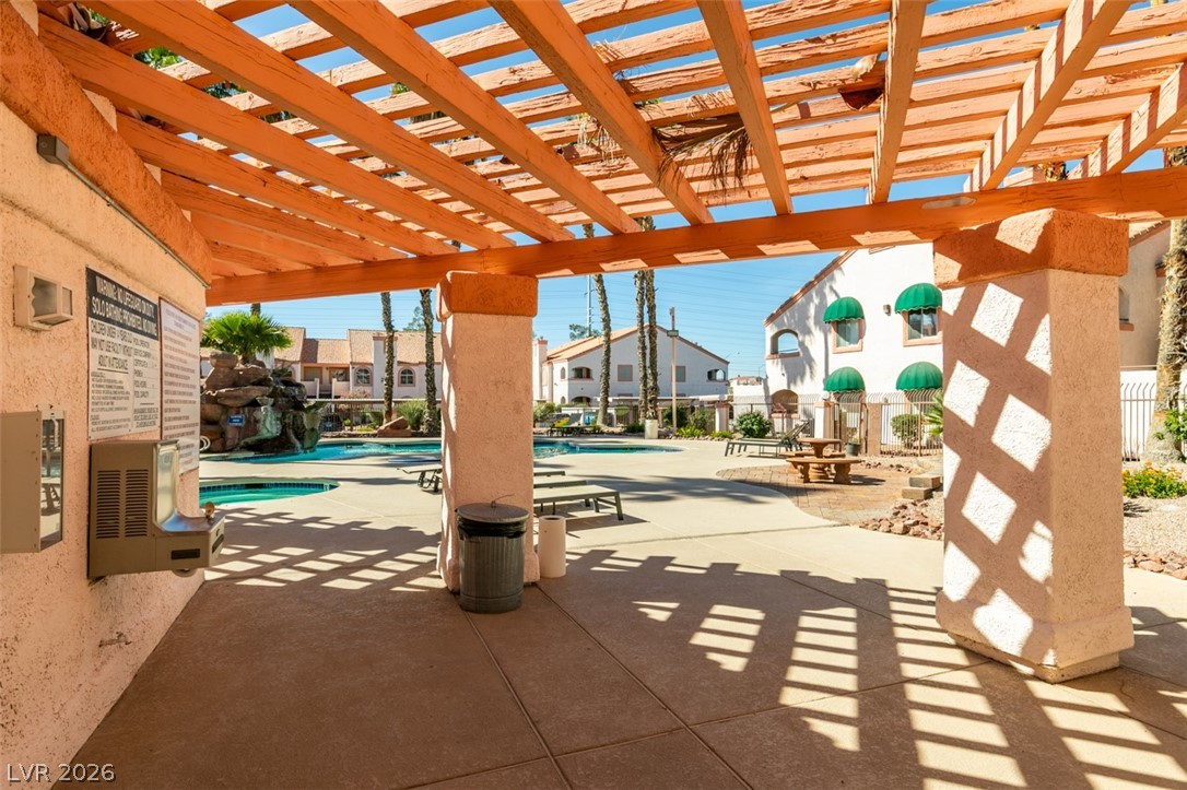 7570 West Flamingo Road, Unit 252 Las Vegas, NV 89147 - Photo 41 of 44 An inviting outdoor community area features a refreshing pool, ample lounging space, and charming pergolas.