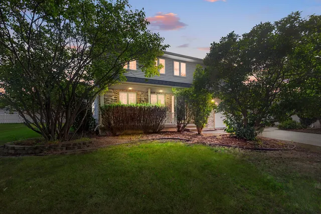 a backyard of a house with table and chairs