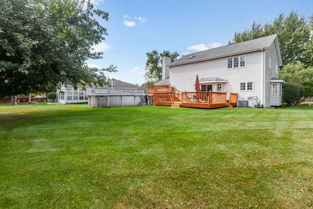 a front view of a house with a garden and deck