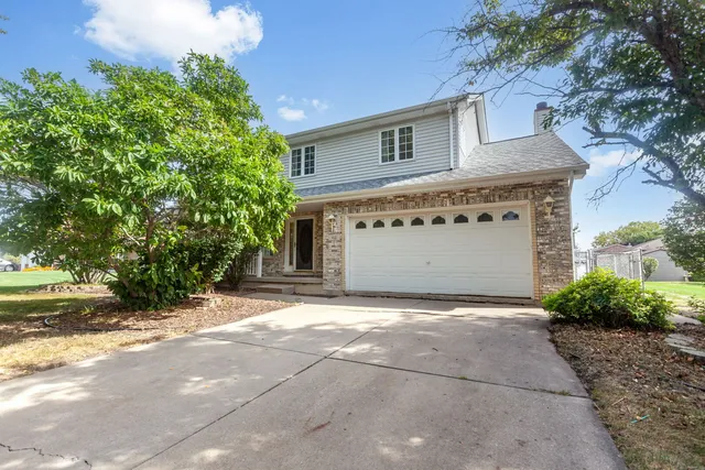 a view of a house with a yard and garage