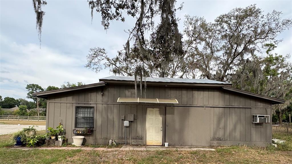 a white house that has tree in front of it