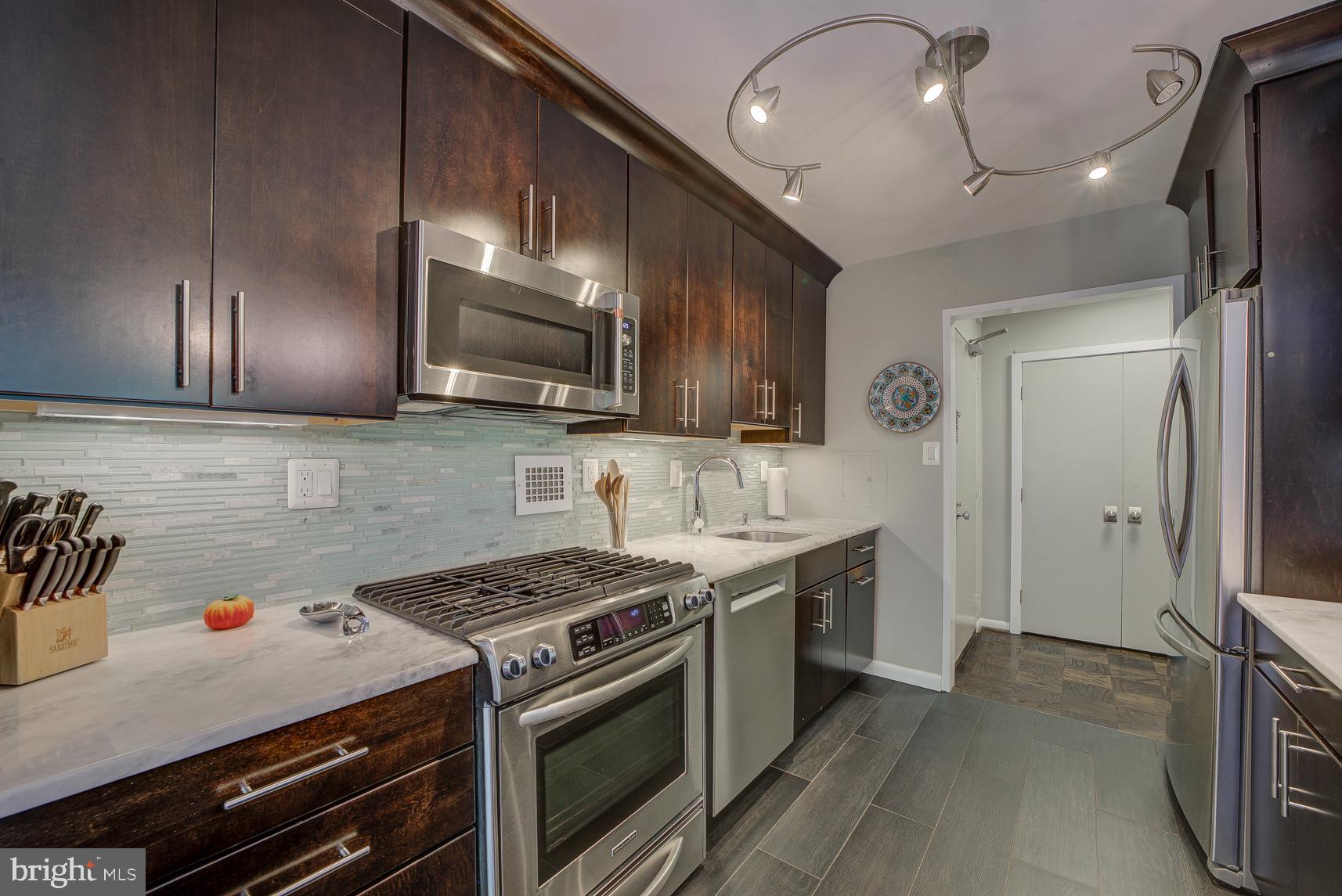 2939 Van Ness Street Northwest, Unit 224 Washington, DC 20008 - Photo 11 of 43 Custom designed kitchen with high-end appliances