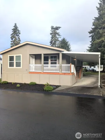 a front view of a house with yard and balcony