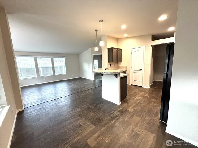 a view of kitchen with sink microwave and refrigerator