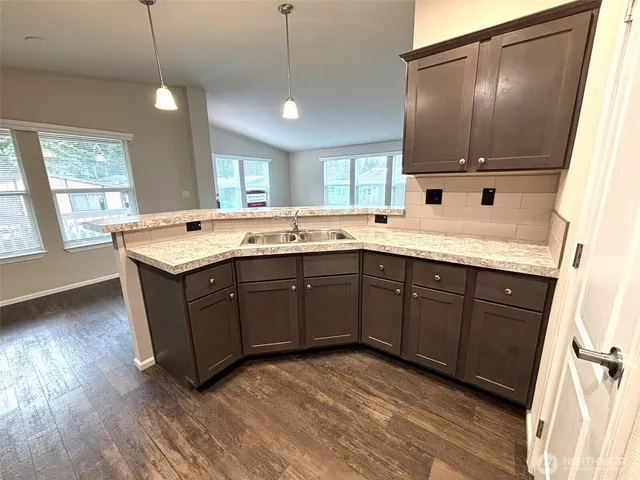 a kitchen with a sink a window and cabinets